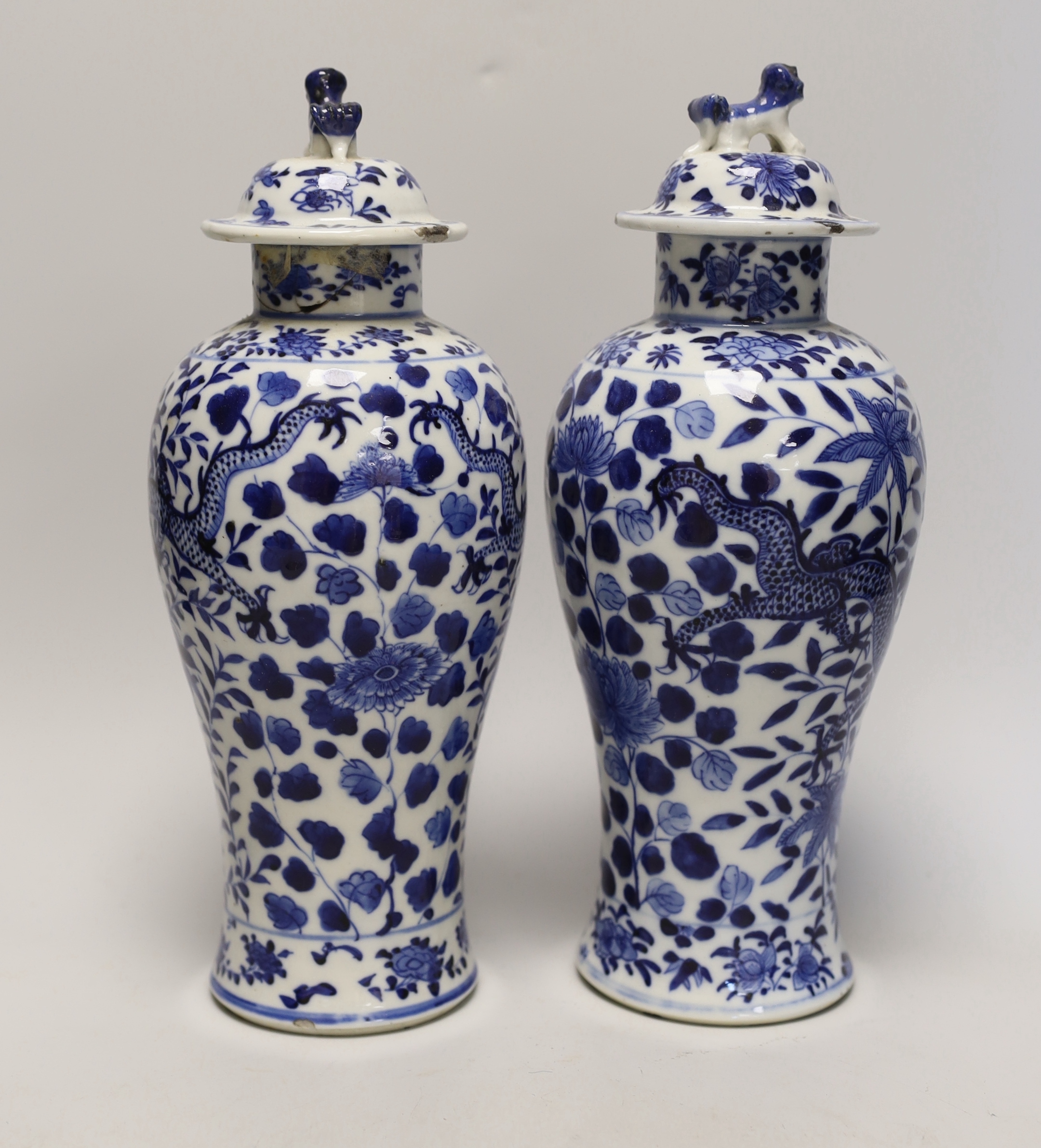 A pair of Chinese blue and white 'dragon’ vases and covers, Late 19th century, 29cm high